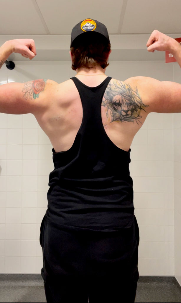 Coach is showing his back flexing.