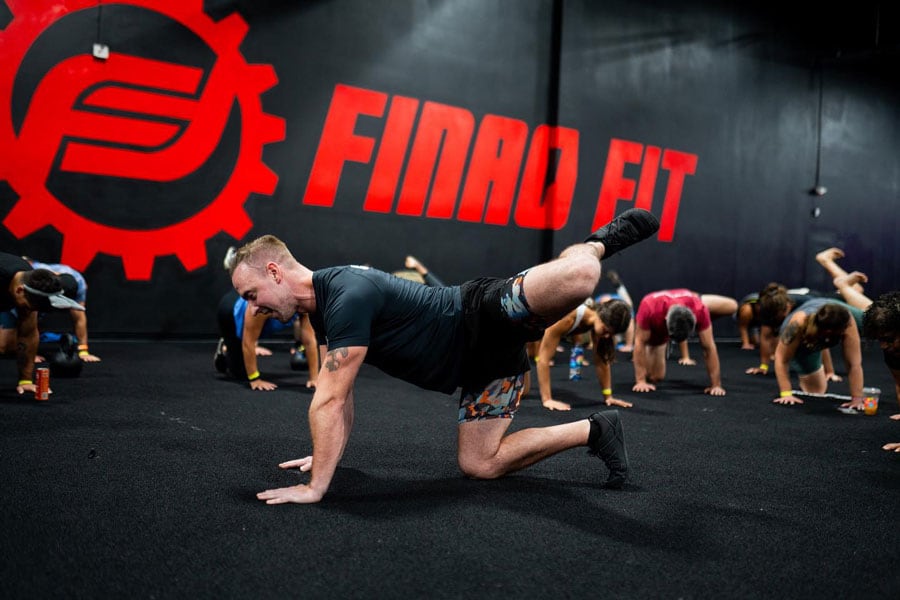Coach is demontrating moves to his clients group.