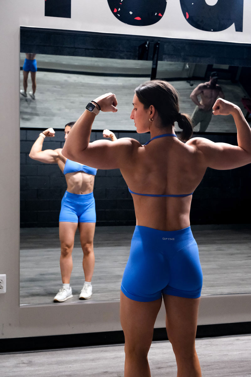 The coach is posing while looking at the mirror.
