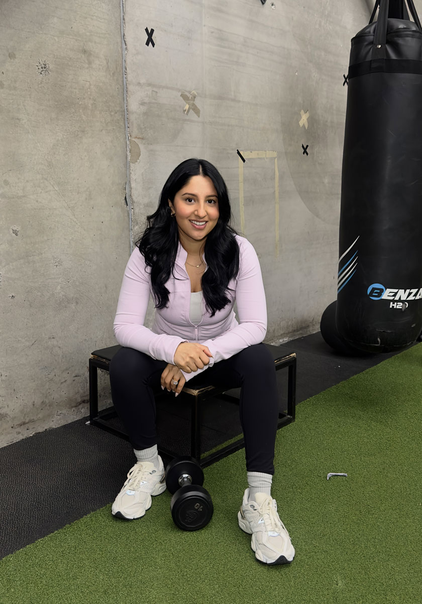 Coach is sitting posing for a photo in the gym.