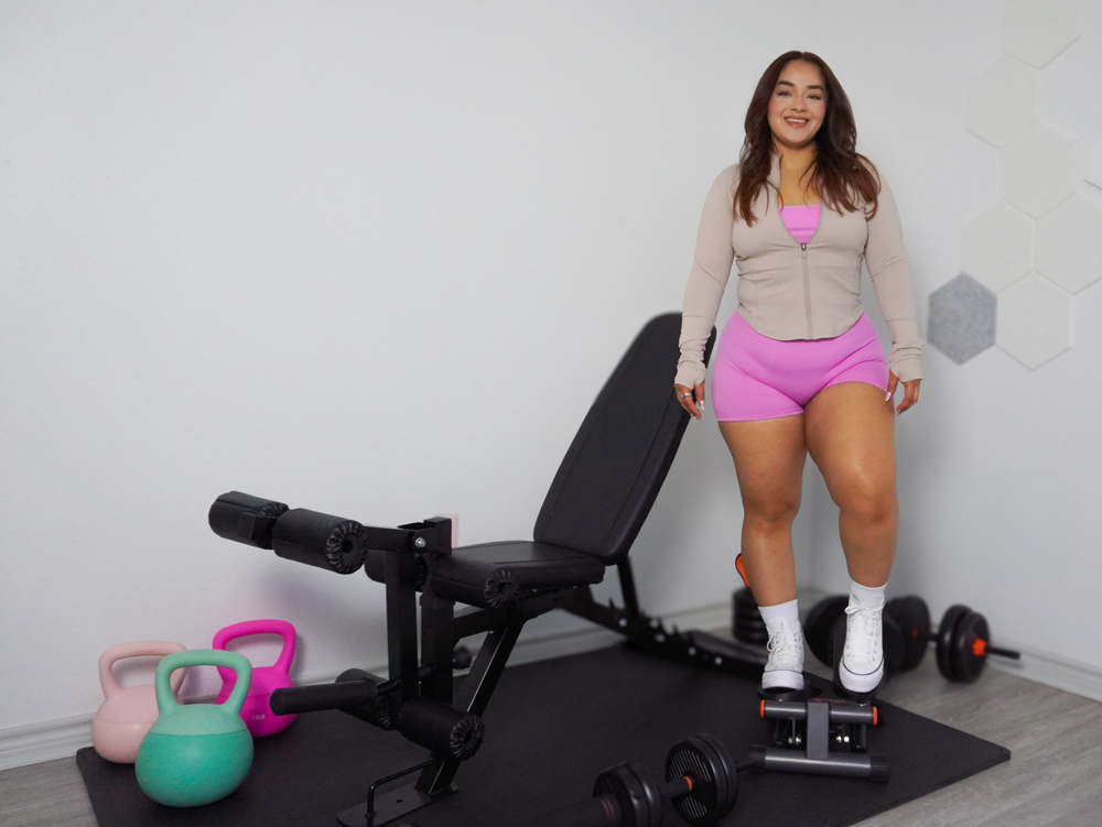 The coach is posing at her home gym.