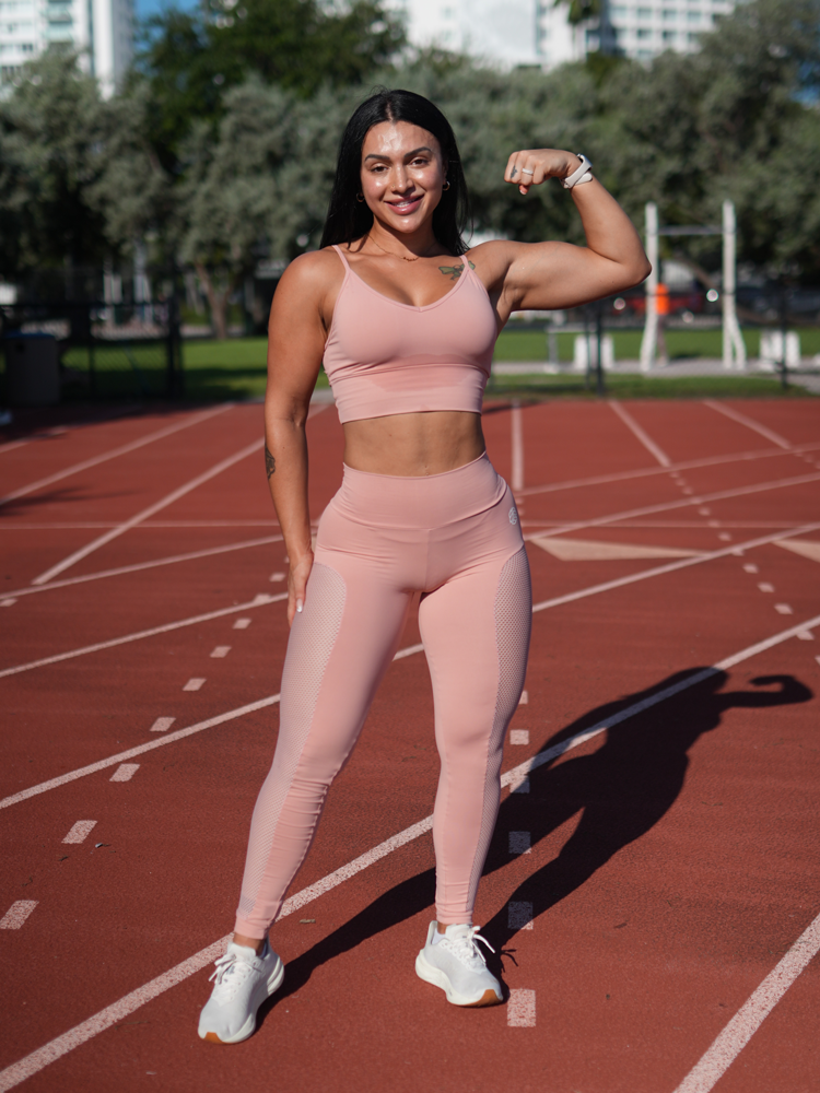 The coach is posing with the confidence while wearing pink clothes.
