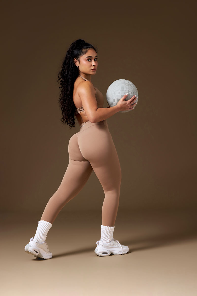 The coach is posing with the ball.