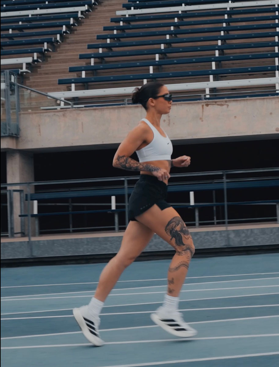 The coach is posing while running.