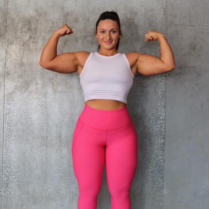 The coach is posing to show her great arm muscles.