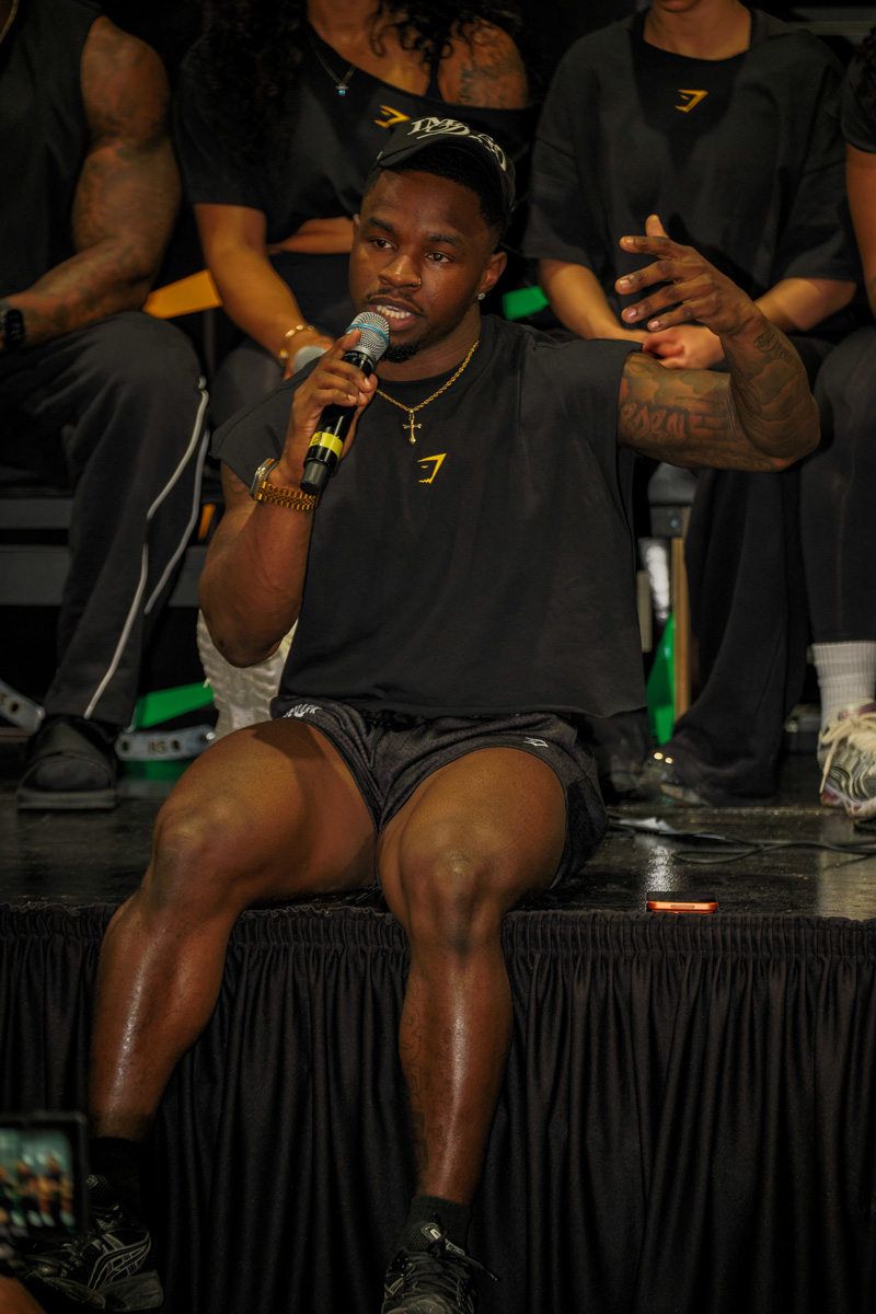 The coach is posing at the gym.
