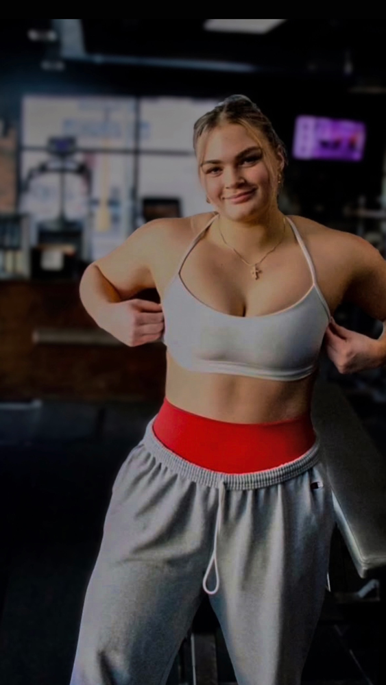 The coach is posing with her confidence.