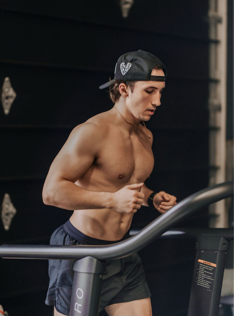 Coach is runnign in treadmill.