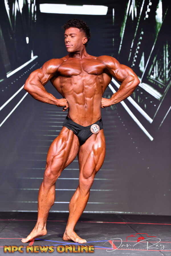 The coach is posing as a bodybuilder.