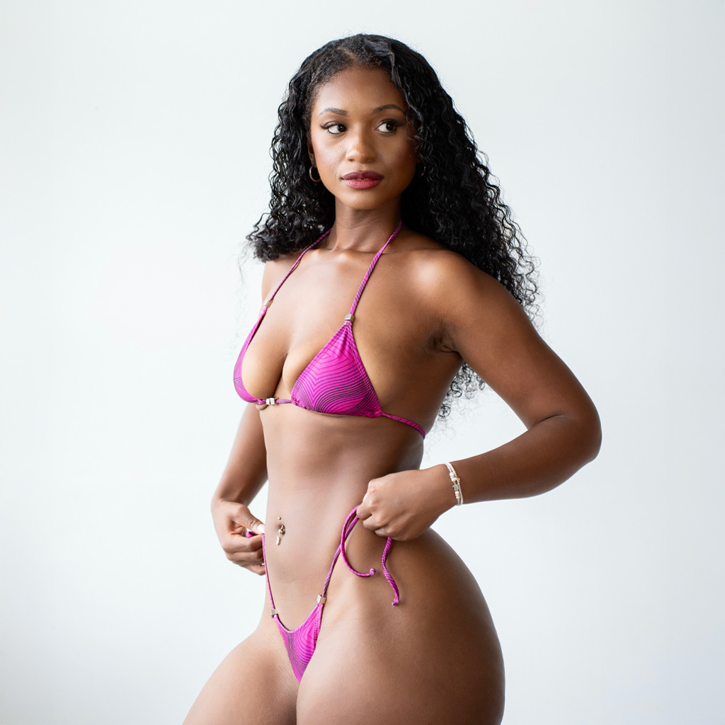 Coach posing with a pink bikini
