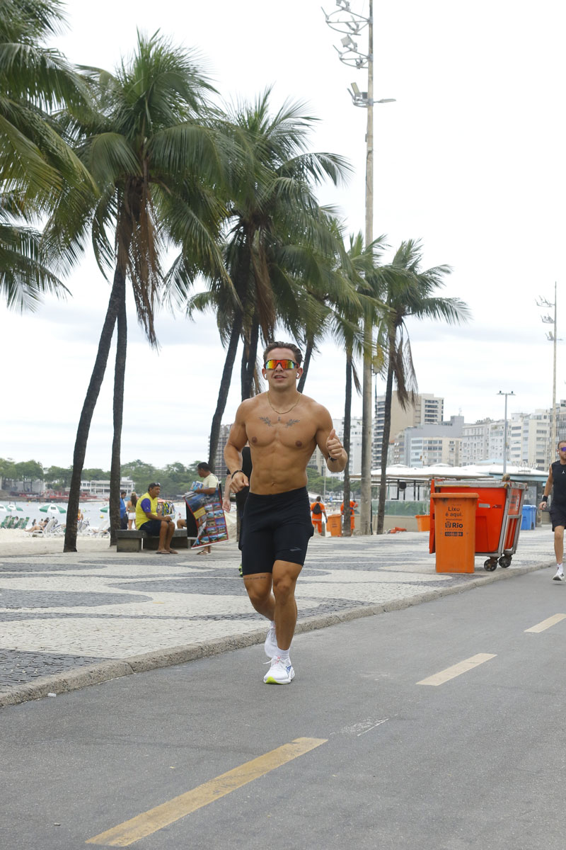 The coach is running near the beach.