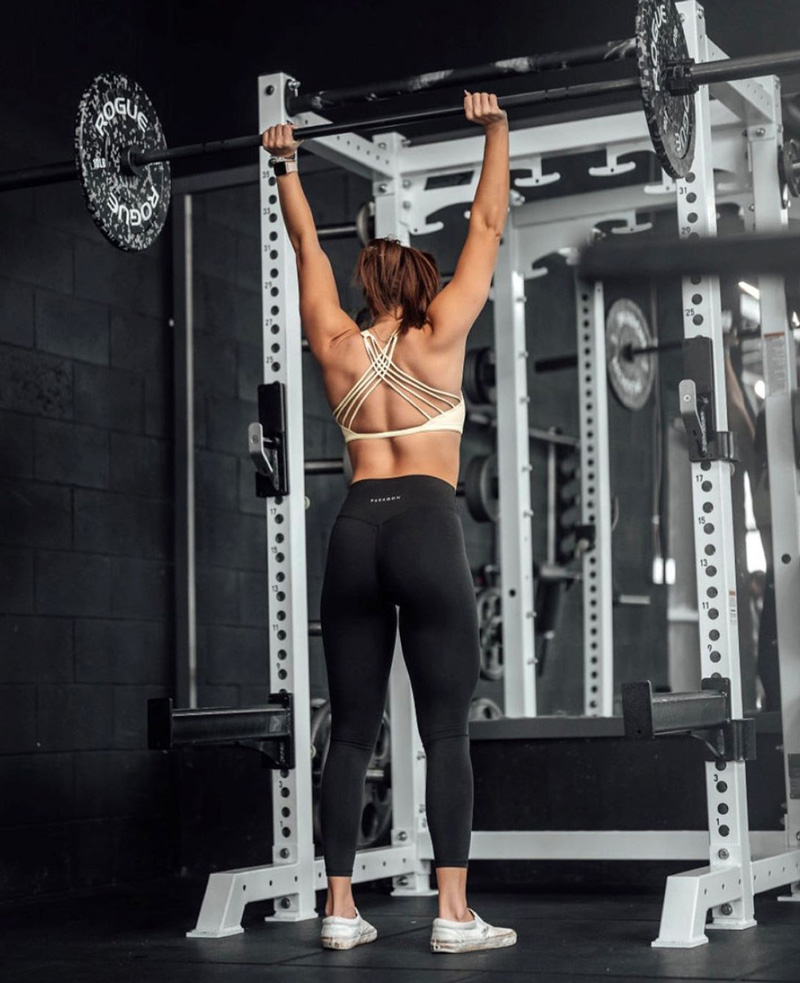 coach in the gym lifting a barbell.