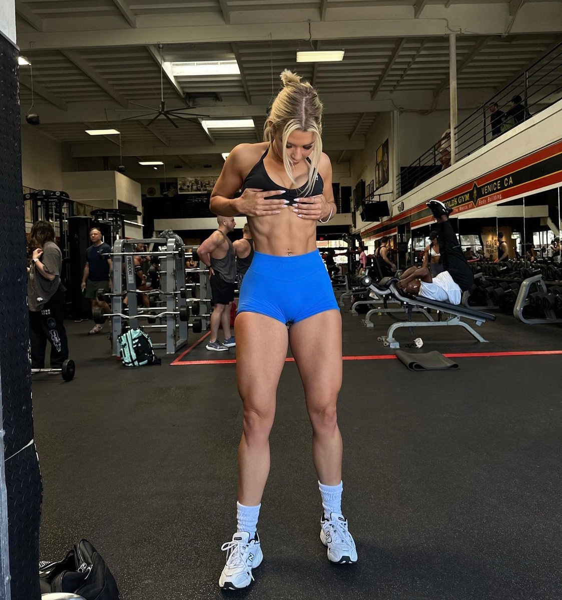 The coach is showing her beautiful muscles.