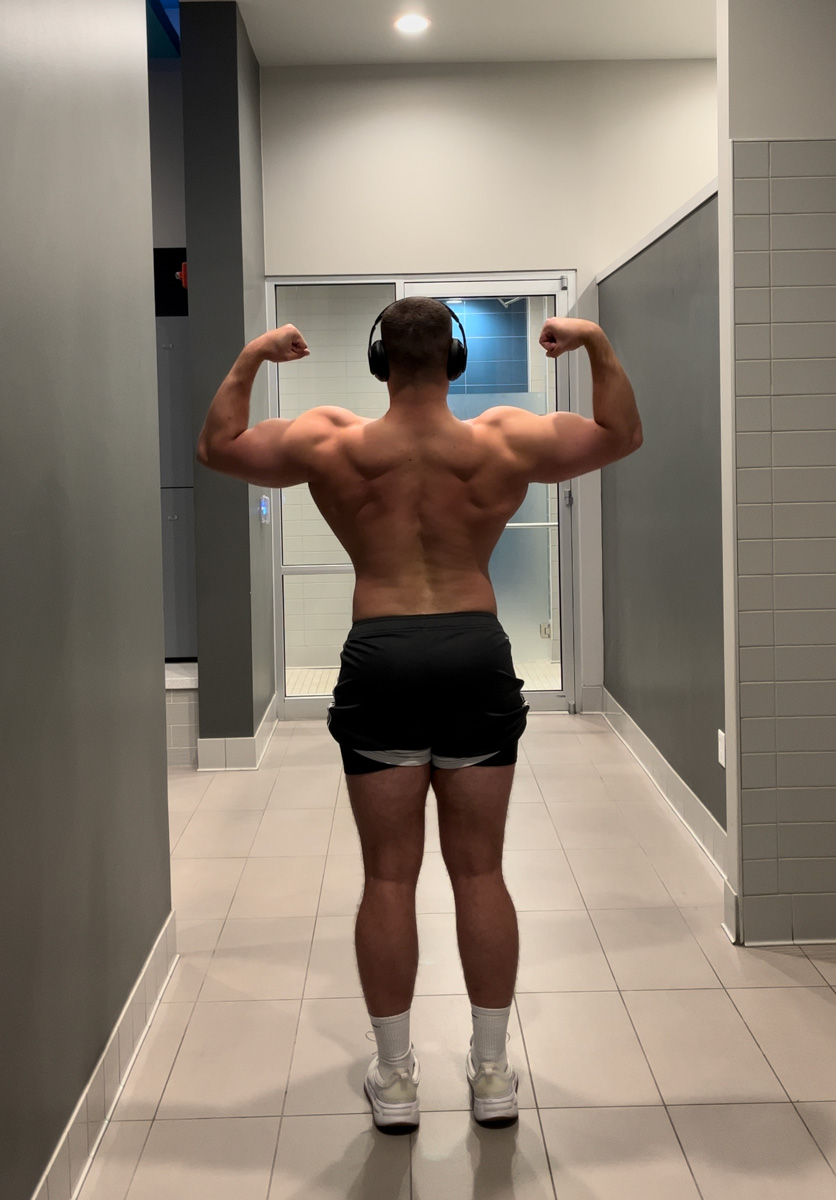 The coach is showing his back muscle.