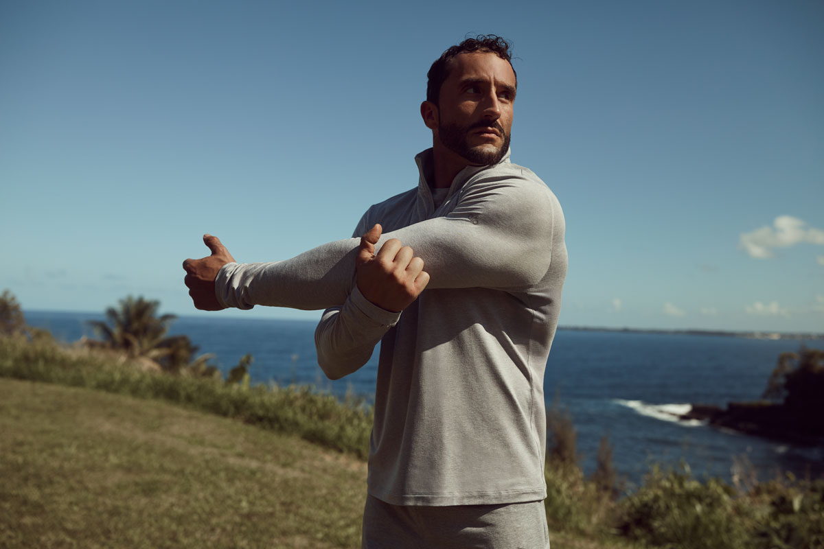 The coach is posing withe beautiful beach background.
