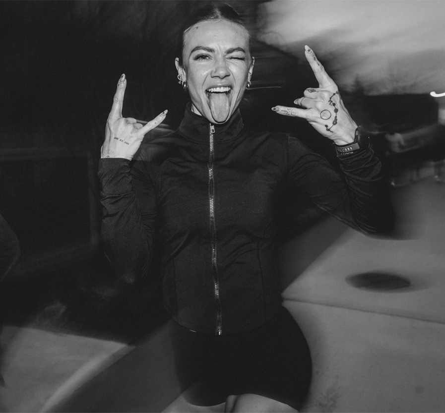 The coach doing devil hands with her tongue sticking out.