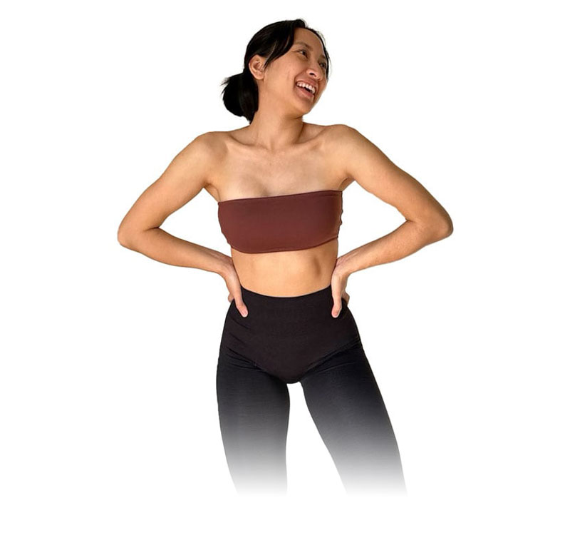 Coach is posing with black leggings and brown bras.