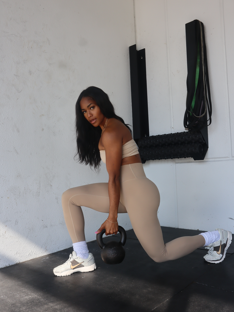 The coach is holding the kettlebell.