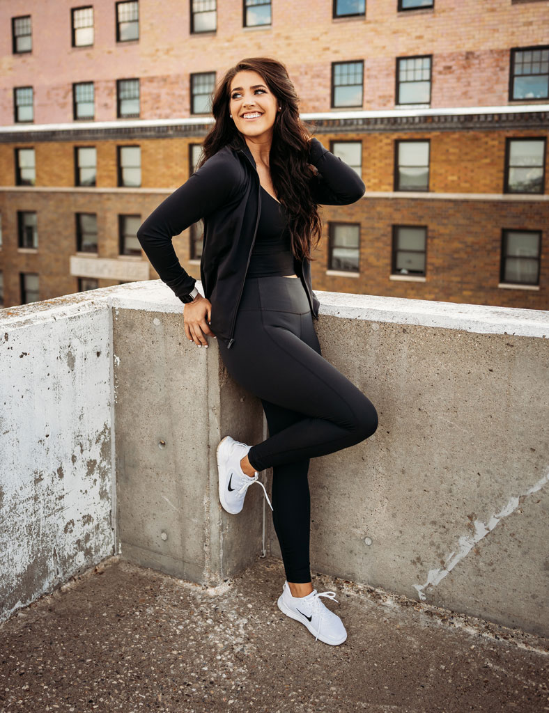 Coach is posing for a picture on a roof of a parking lot.