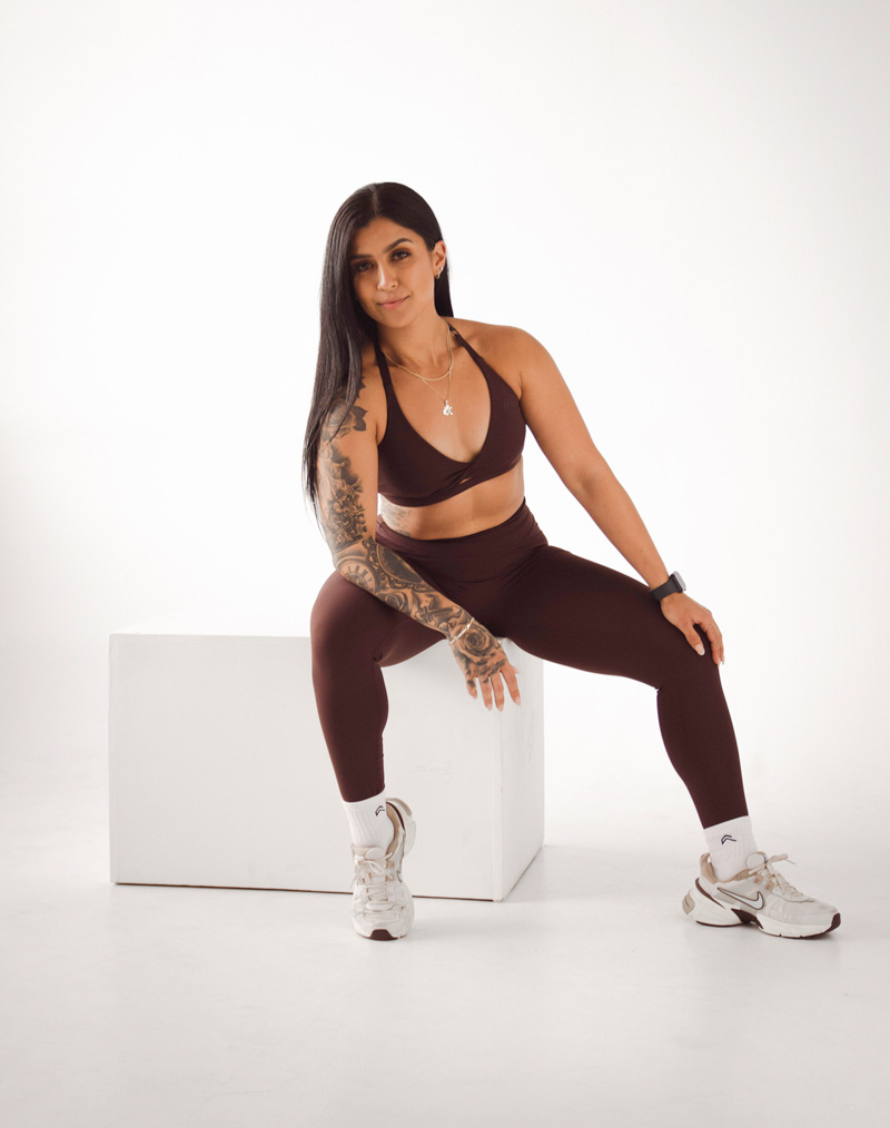 Coach is posing with a brown workout outfit.