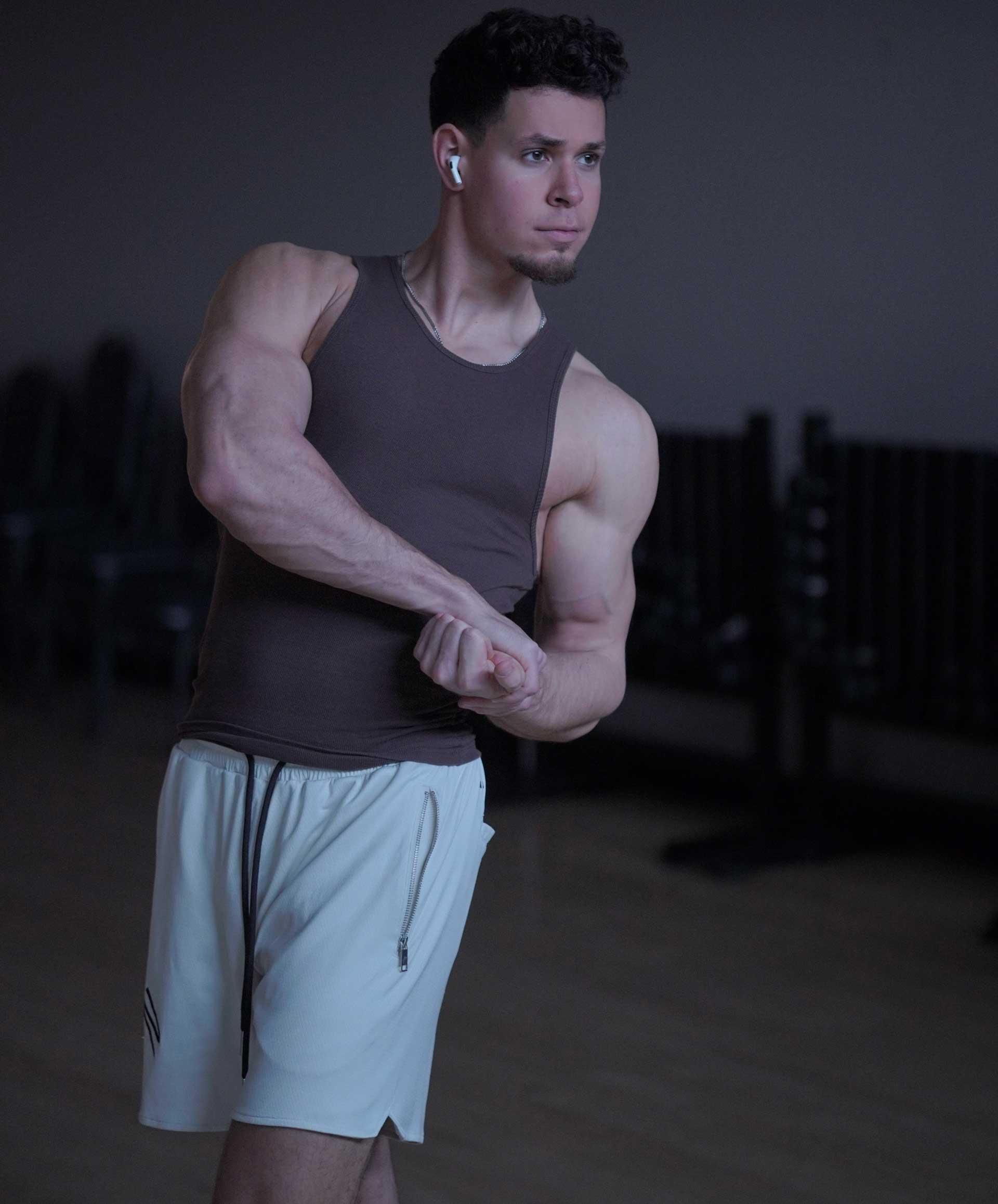 Coach posing to show toned body.