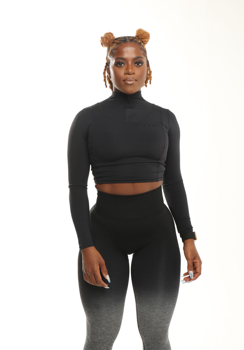 The coach is posing while wearing black clothing.