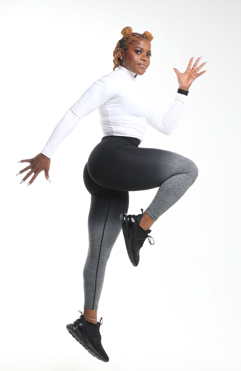 The coach is posing while jumping.